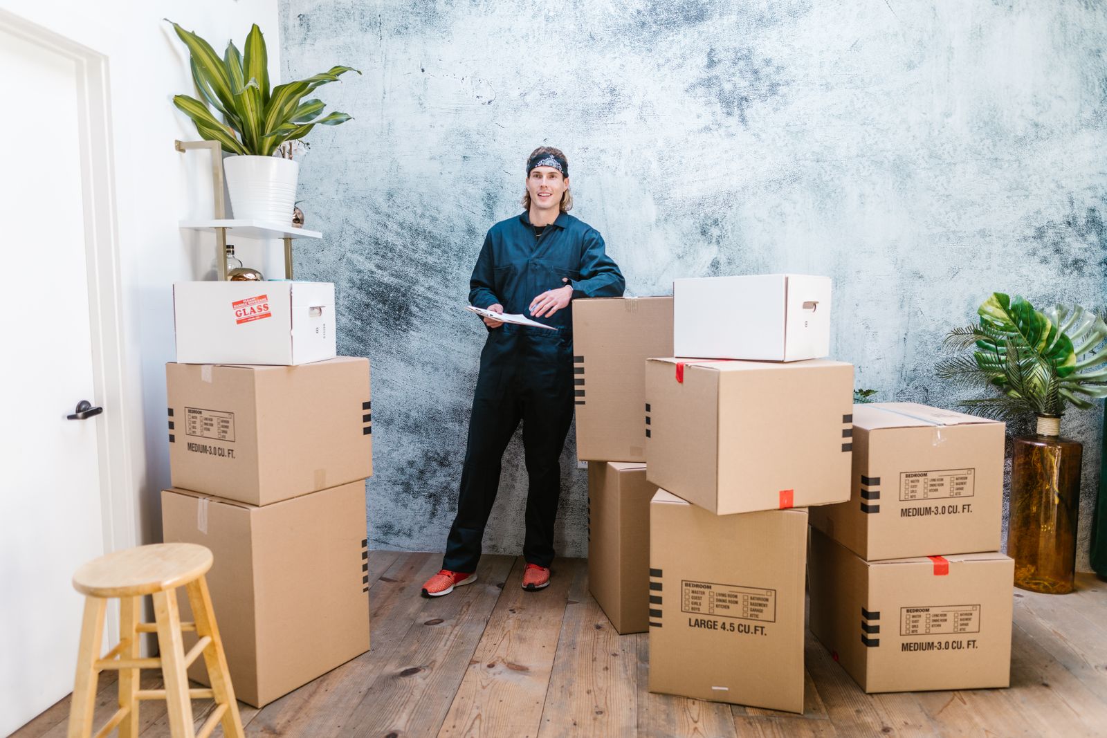 A relocation supervisor with a clipboard and labelled cartons